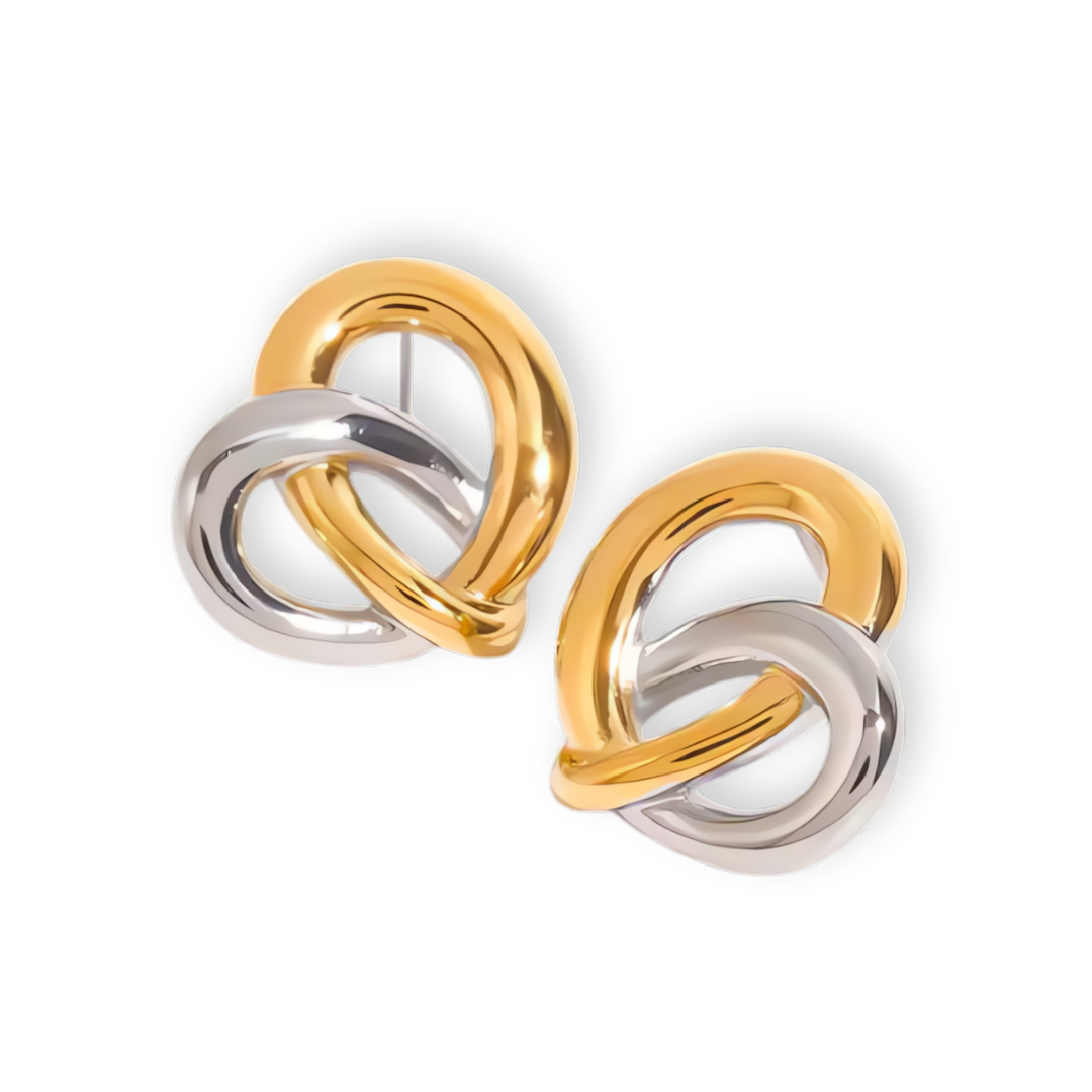 Heart-shaped earrings with interwoven gold and silver tones. 18K gold-plated, hypoallergenic, and crafted for everyday elegance and symbolism.