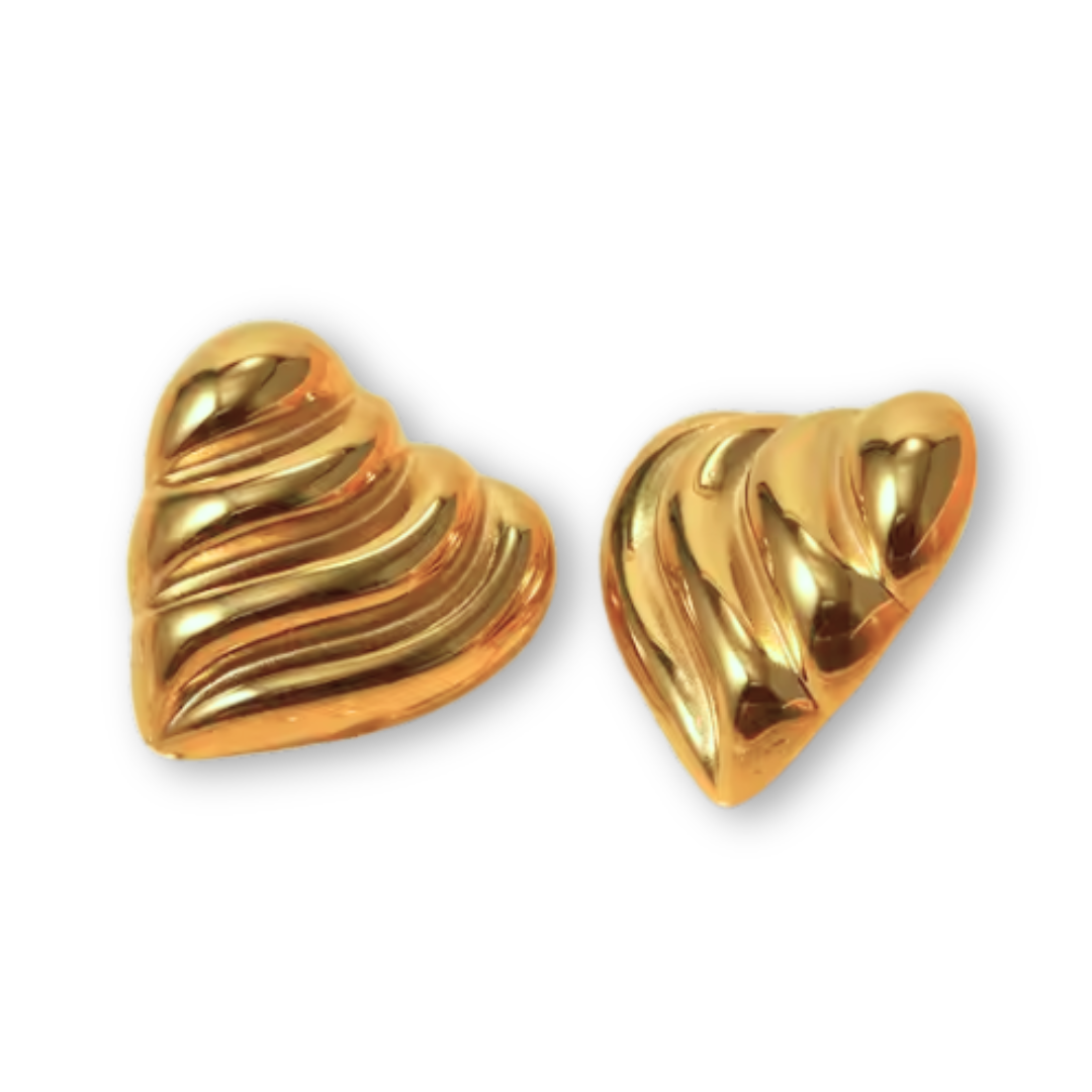 Pair of sculpted heart-shaped stud earrings in 18K gold PVD with a textured, dune-inspired finish on a white background