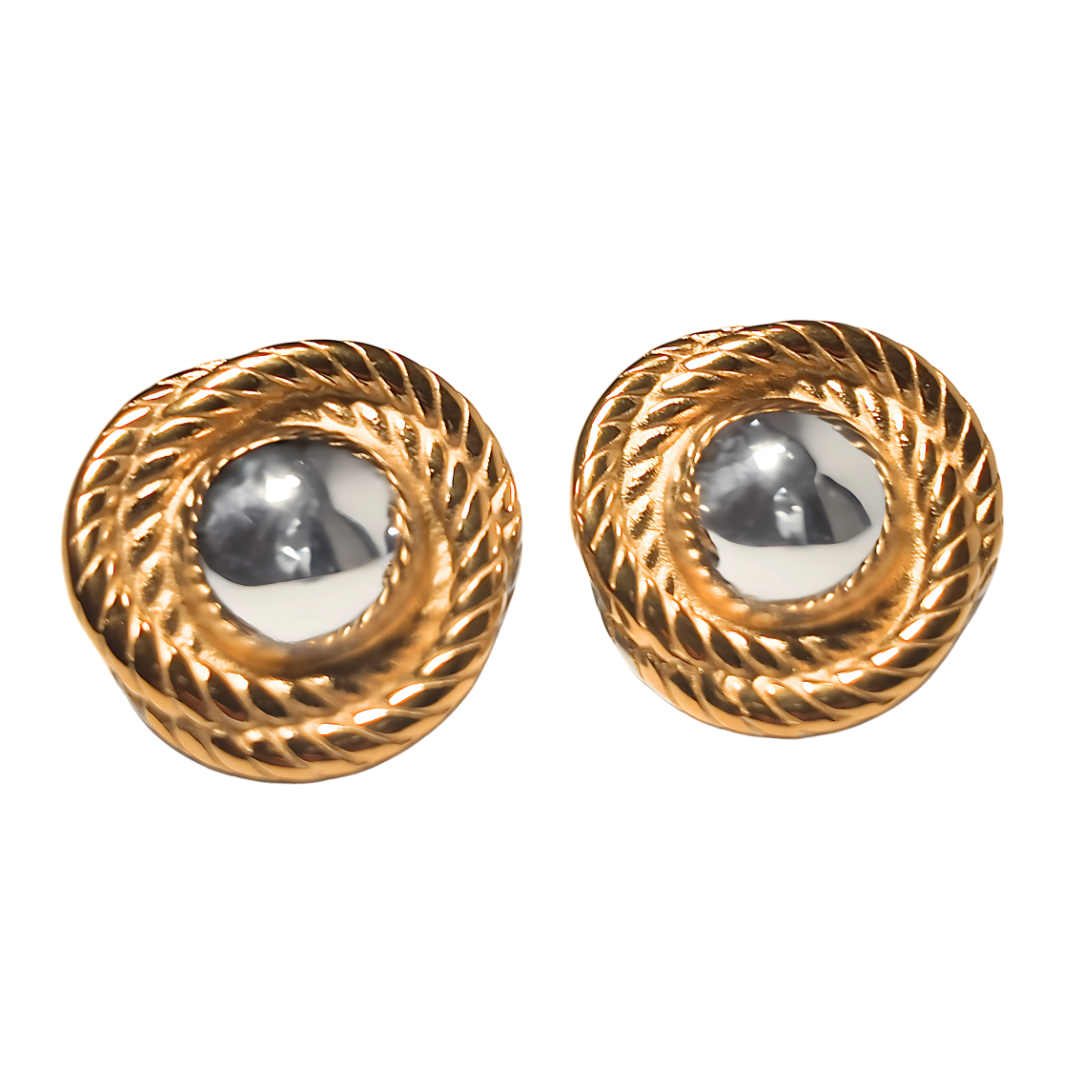 Equinox earrings featuring twisted gold rope design and polished silver-toned centre, photographed on white background.